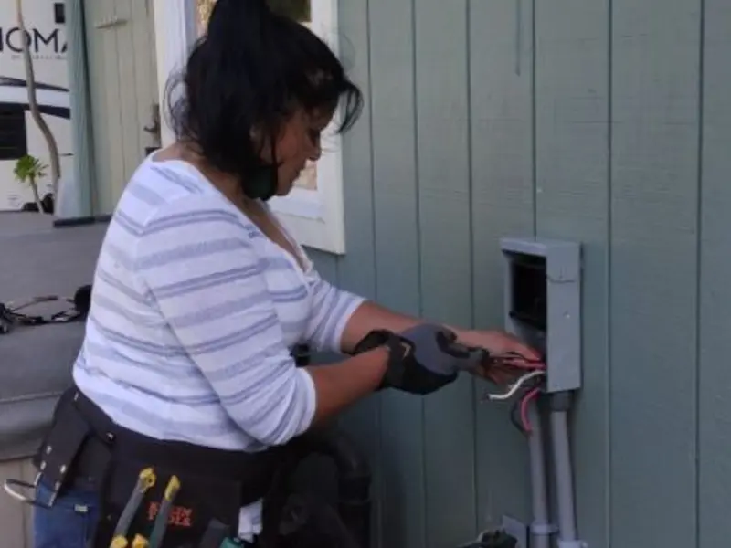 Licensed electrician wiring an exterior subpanel in The Crossings